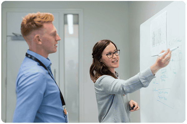 Resolution Digital SEO Consulting team discussing tools and technology while writing in white board
